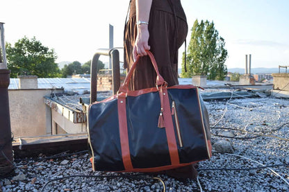 "Classy black Travel bag with dark orange handle"