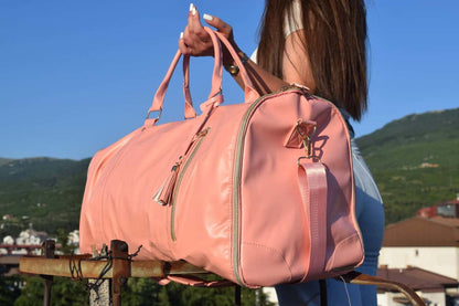 "Soft pink Travel bag with pink handles"